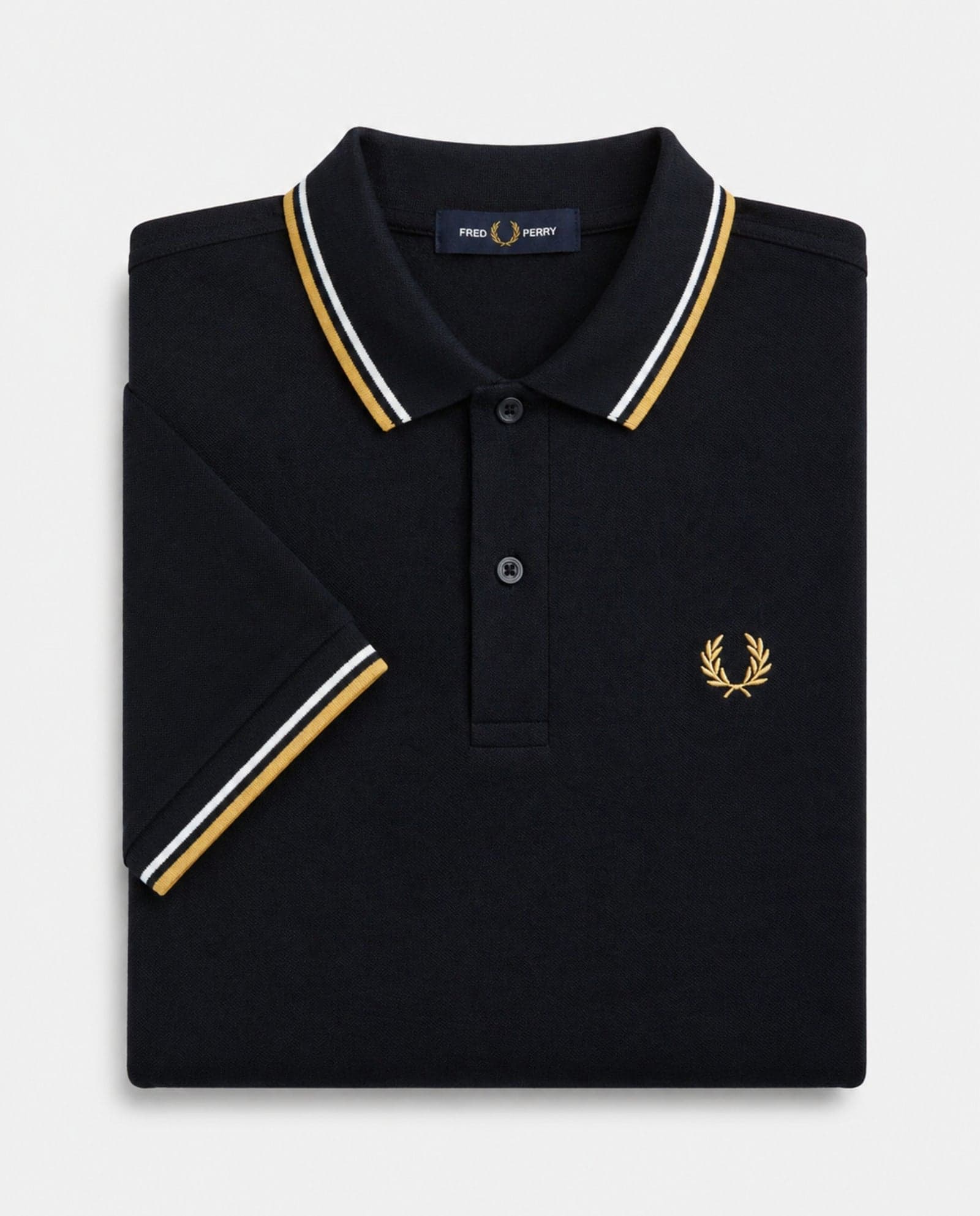 Polo de algodón doble banda negro dorado Fred Perry